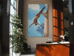Large painting of a man diving into water hanging on the wall in a corporate building that was hung by Art Hangers