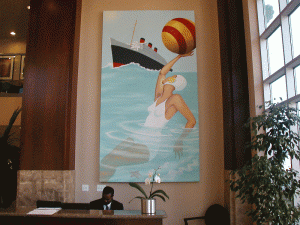 Large wall painting of a woman in the ocean with a beach ball and a large ship in the background installed by professional art Installers - Art Hangers