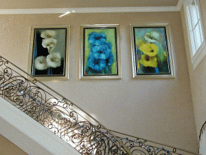 three large framed flower paintings hung in stairwell - Art Hangers Installation 