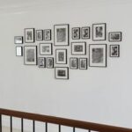 collage of small black and white photos installed over railing - Art Hangers Installation 