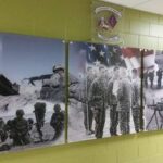 Army acrylic pictures hung on stone wall - Art Hangers