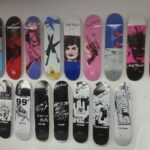 Skateboards hung on wall to showcase designs on back - Art Hangers