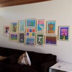 Framed colorful collage hung on a family room wall by professionals at Art Hangers